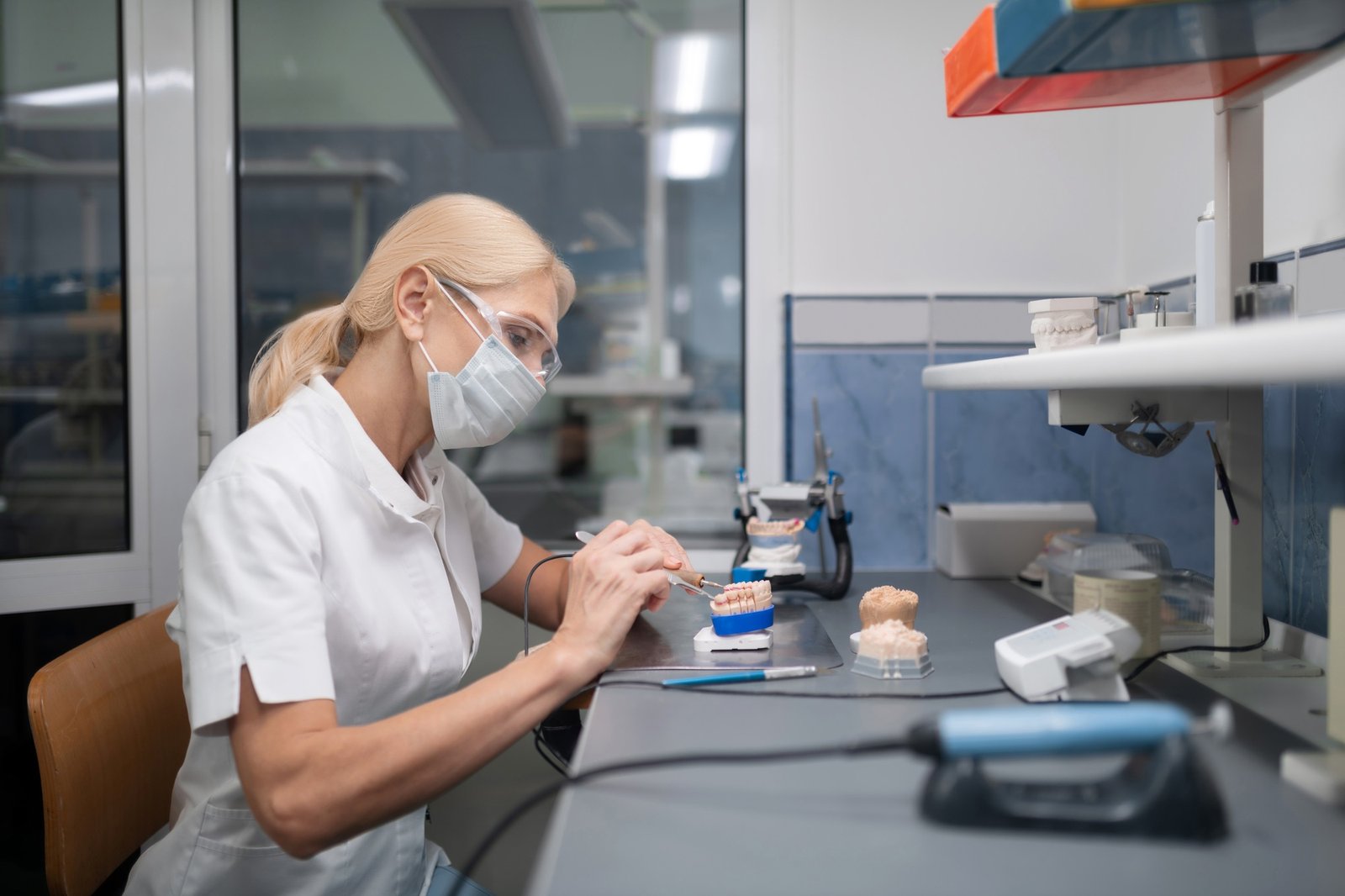 Dental technician constructing porcelain veneers for the patient