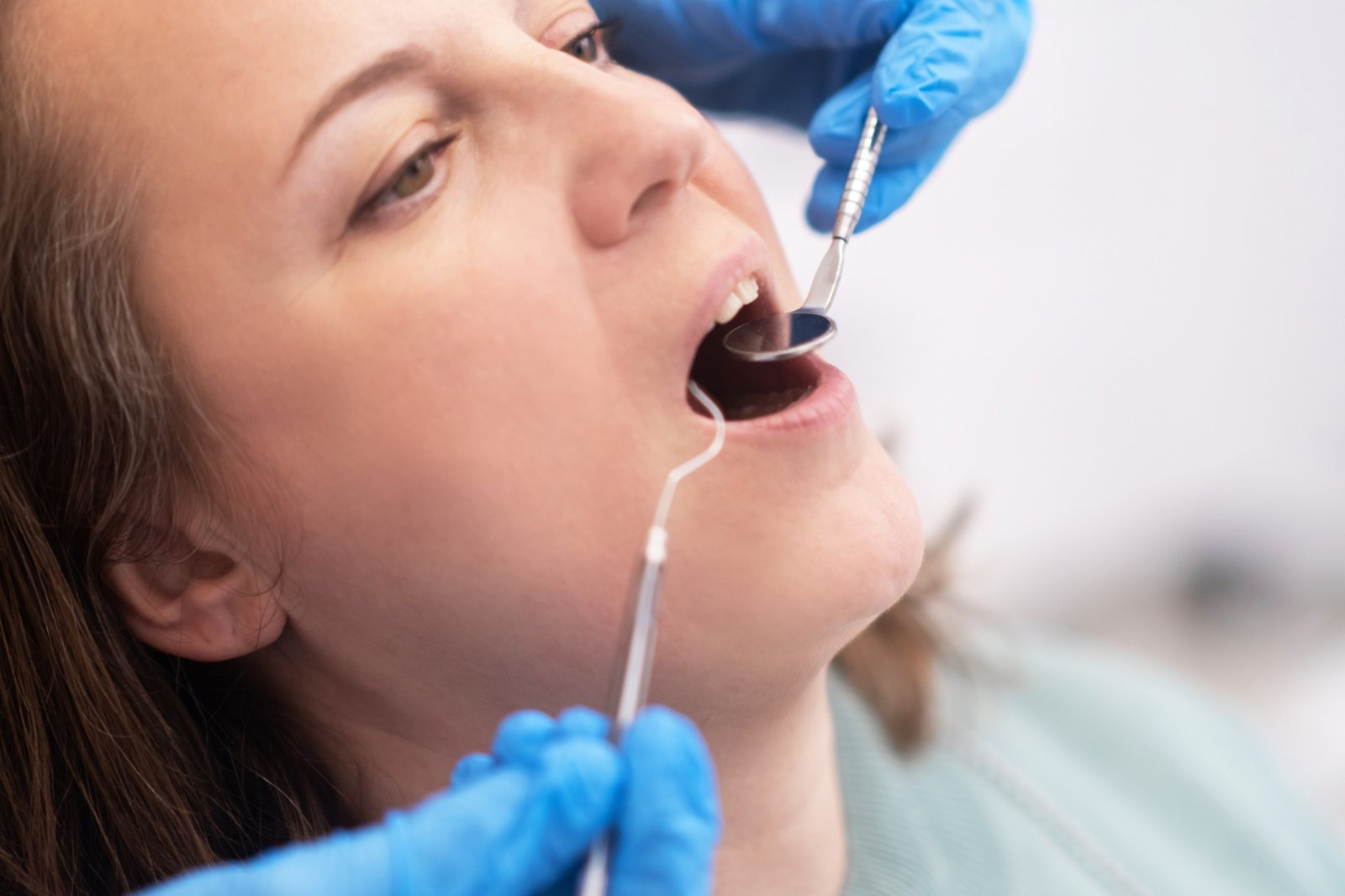 female patient receiving expert dental therapy from a skilled dentist in a sterile clinic