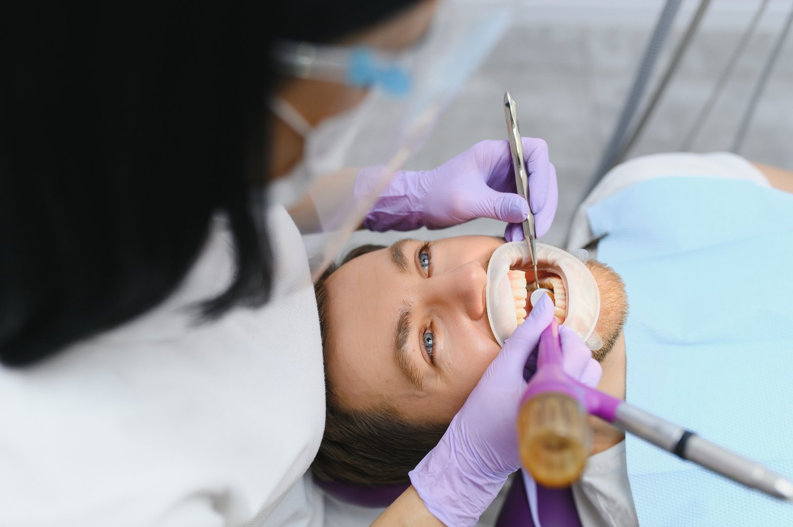 Periodontal Services. Closeup Shot Of Smiling Man Getting Treatment In Stomatologic Clinic